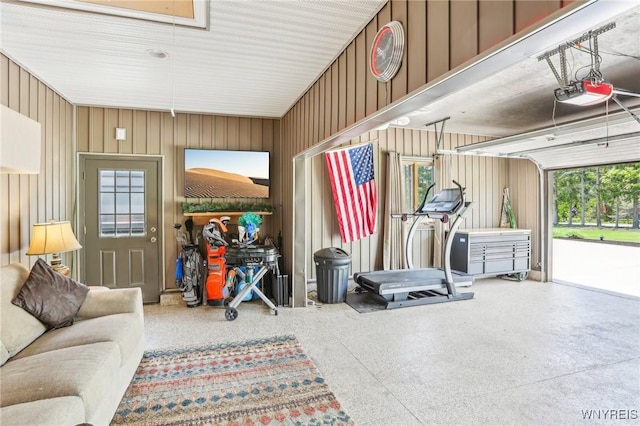 exercise room with attic access and a garage