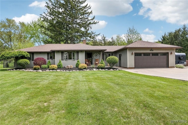ranch-style home featuring a chimney, a garage, driveway, and a front yard