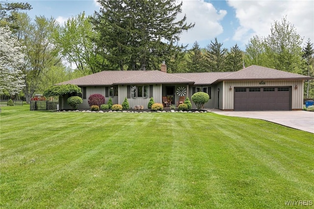 ranch-style home with a garage, a chimney, a front lawn, driveway, and roof with shingles