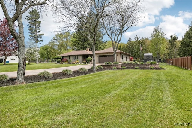 view of yard featuring driveway and a garage