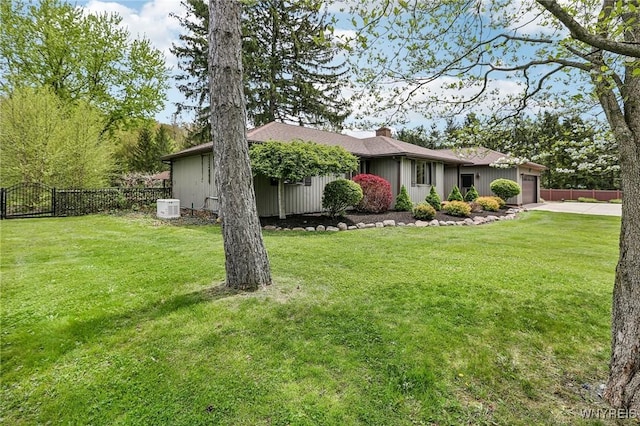 view of front of property featuring an attached garage, driveway, and a chimney