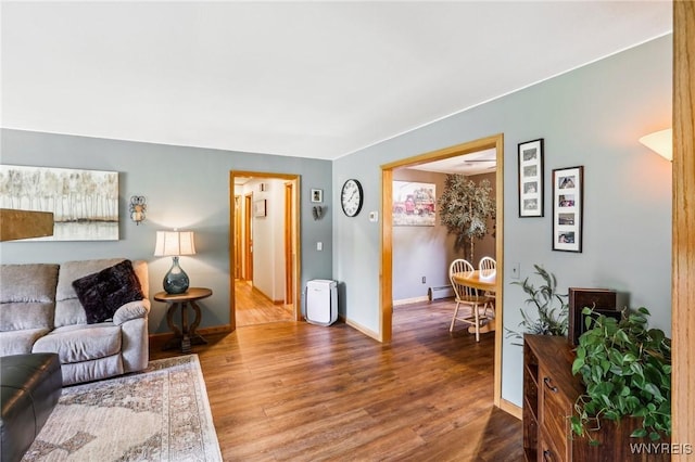living area featuring wood finished floors and baseboards