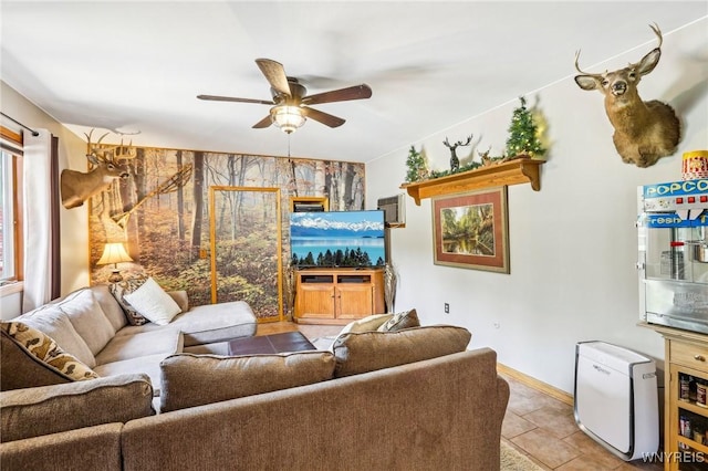 living room featuring ceiling fan, baseboards, and light tile patterned floors