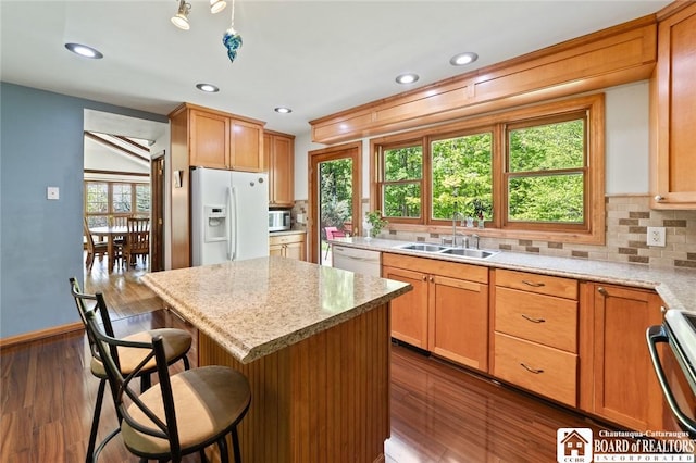 24 Castile Dr, Pomfret, NY 14063 - kitchen with white appliances, a sink, tasteful backsplash, a breakfast bar area, and recessed lighting