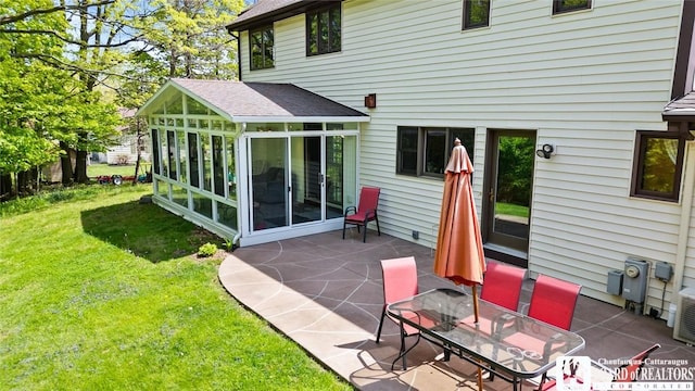 24 Castile Dr, Pomfret, NY 14063 - rear view of house featuring a sunroom, a patio area, and a yard