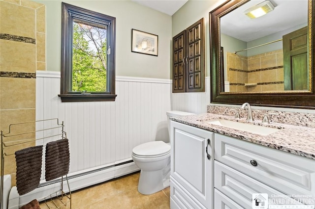 24 Castile Dr, Pomfret, NY 14063 - full bath with baseboard heating, wainscoting, tile patterned flooring, toilet, and vanity