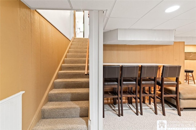 24 Castile Dr, Pomfret, NY 14063 - stairs featuring carpet, a bar, and wooden walls
