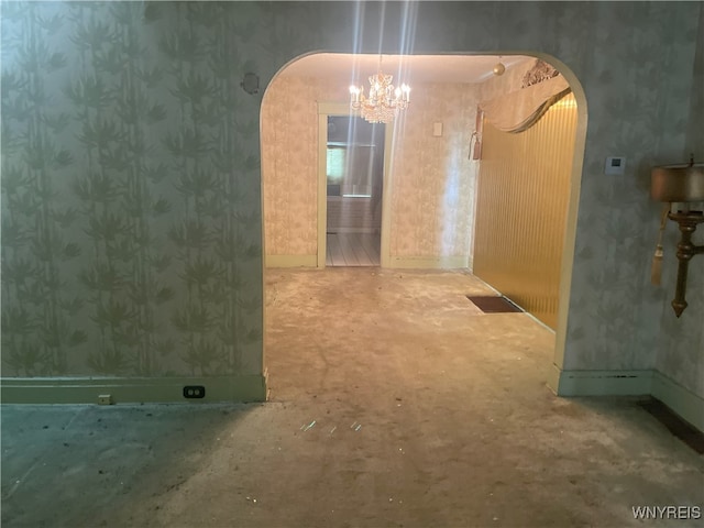 14 Thornton Ave, Buffalo, NY 14215 - hall with arched walkways, wallpapered walls, a chandelier, and baseboards