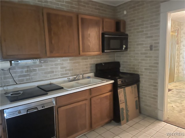 14 Thornton Ave, Buffalo, NY 14215 - kitchen with black appliances, a sink, light countertops, brown cabinetry, and light tile patterned floors