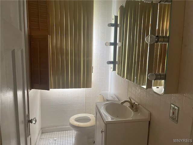 14 Thornton Ave, Buffalo, NY 14215 - bathroom featuring tile walls, toilet, vanity, and tile patterned floors