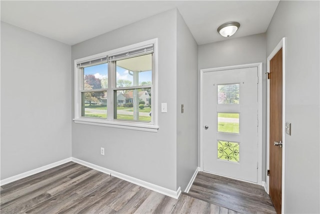 foyer entrance with wood finished floors and baseboards