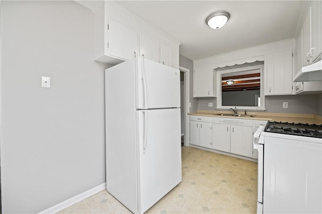kitchen featuring white appliances, a sink, light countertops, and white cabinetry