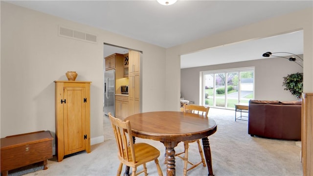 dining room with light colored carpet