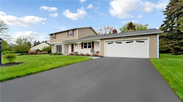 traditional-style home with driveway, a chimney, a garage, and a front yard