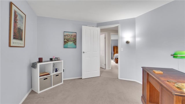 corridor with light colored carpet and baseboards