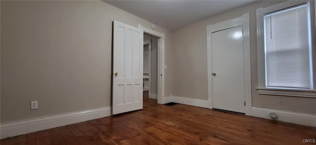 221 Grace St, Syracuse, NY 13204 - unfurnished bedroom with hardwood / wood-style flooring and baseboards