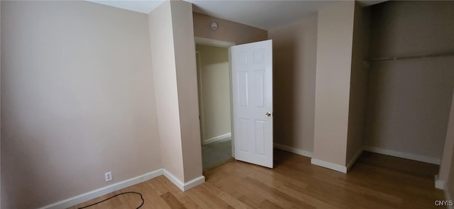 221 Grace St, Syracuse, NY 13204 - unfurnished bedroom featuring light wood finished floors and baseboards