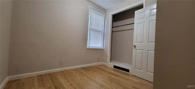 221 Grace St, Syracuse, NY 13204 - unfurnished bedroom with light wood-style flooring, baseboards, and a closet