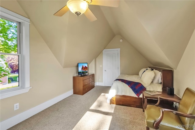 carpeted bedroom featuring vaulted ceiling, a ceiling fan, and baseboards