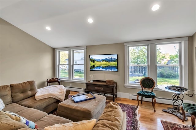 living room with healthy amount of natural light, wood finished floors, a baseboard radiator, recessed lighting, and vaulted ceiling