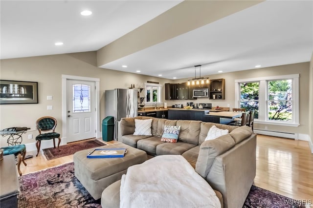 living room featuring baseboard heating, recessed lighting, light wood-type flooring, lofted ceiling, and baseboards