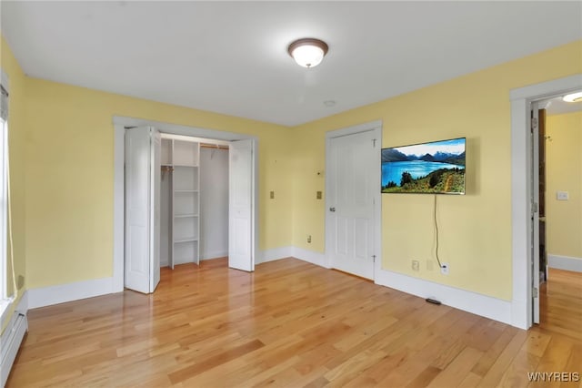 unfurnished bedroom featuring light wood finished floors and baseboards
