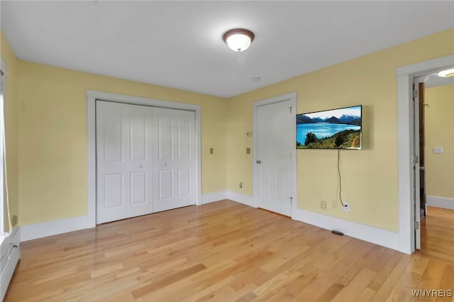 unfurnished bedroom with light wood-style floors and baseboards