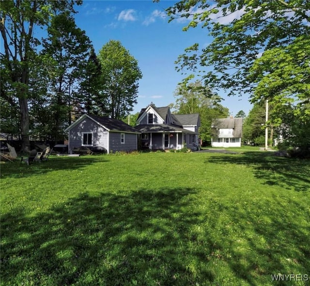 back of property featuring a yard and a porch