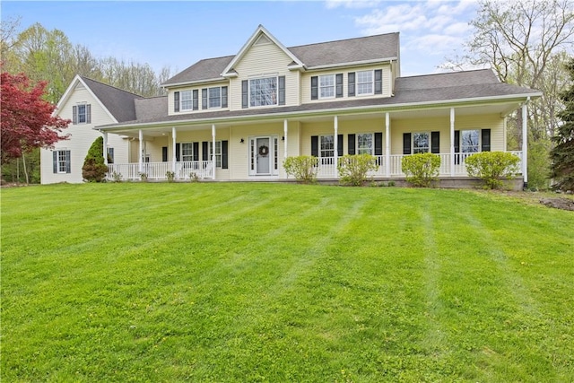 colonial inspired home featuring a porch and a front yard