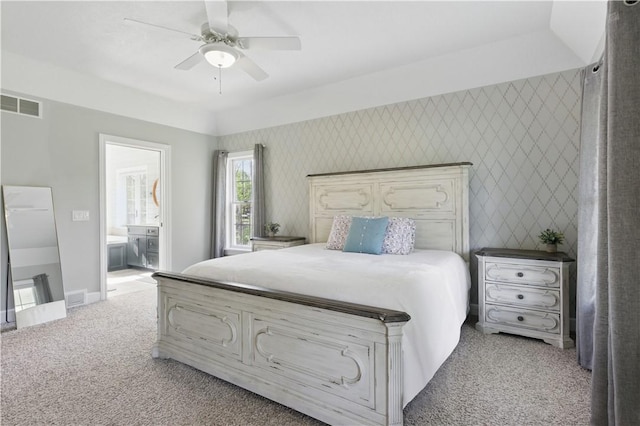 bedroom with light carpet, baseboards, connected bathroom, and ceiling fan