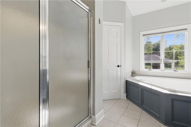bathroom featuring a shower stall, tile patterned floors, and a bath