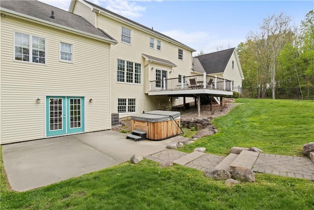 back of house featuring a hot tub, a patio area, and a deck