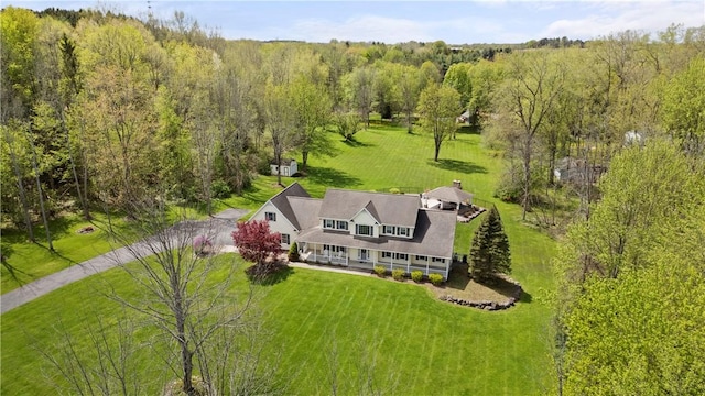 view from above of property featuring a heavily wooded area