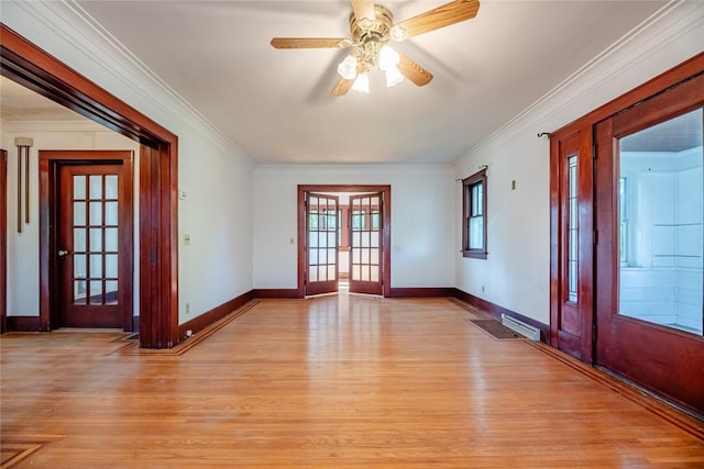 empty room featuring light wood-style flooring, crown molding, baseboards, and ceiling fan