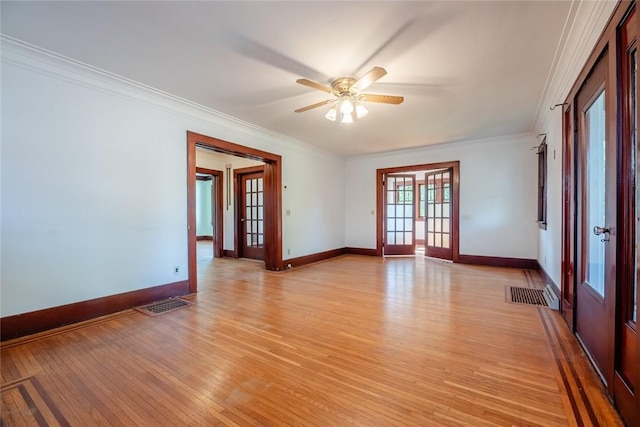 spare room with french doors, light wood finished floors, crown molding, ceiling fan, and baseboards
