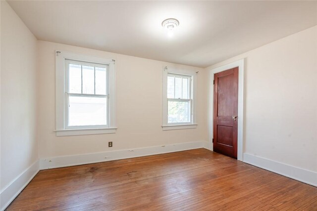 empty room featuring wood-type flooring and plenty of natural light