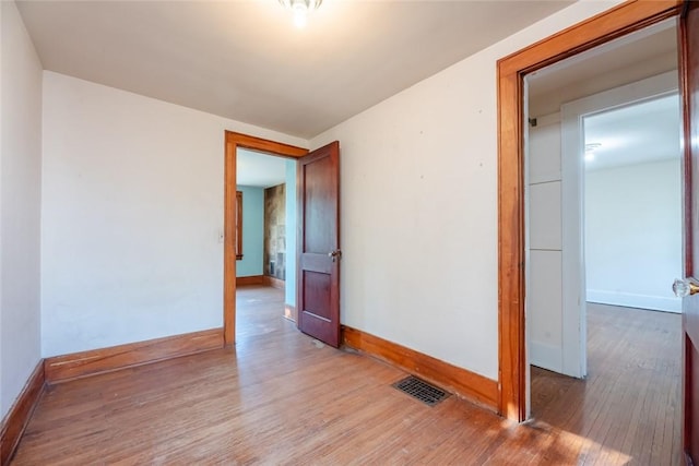 unfurnished room with wood finished floors and baseboards