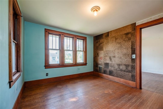 empty room with wood finished floors and baseboards