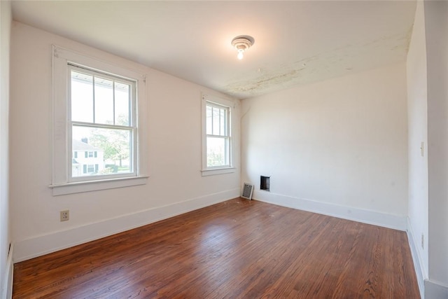 empty room with wood finished floors and baseboards