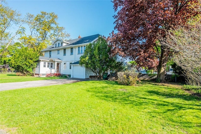 view of front of house with driveway, an attached garage, and a chimney