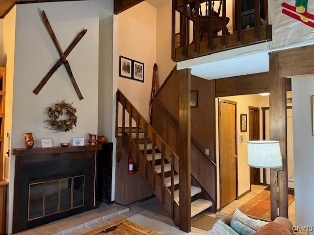 2128 Beta Dr Unit 21E, Virgil, NY 13045 - stairway featuring tile patterned floors and a glass covered fireplace
