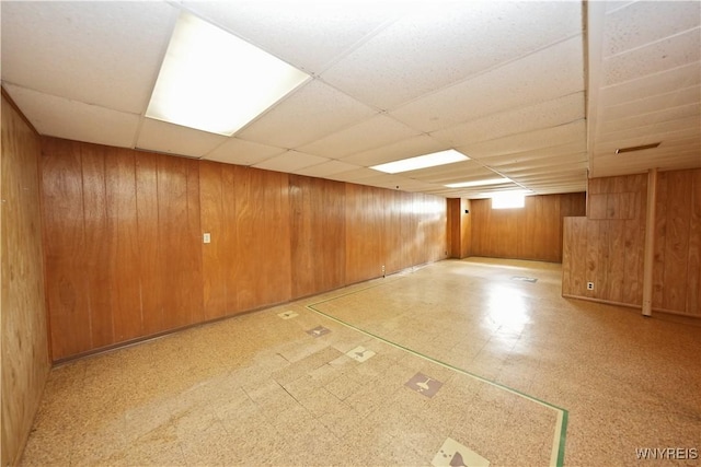 41 Della Dr, Lackawanna, NY 14218 - below grade area featuring tile patterned floors, wooden walls, and a drop ceiling