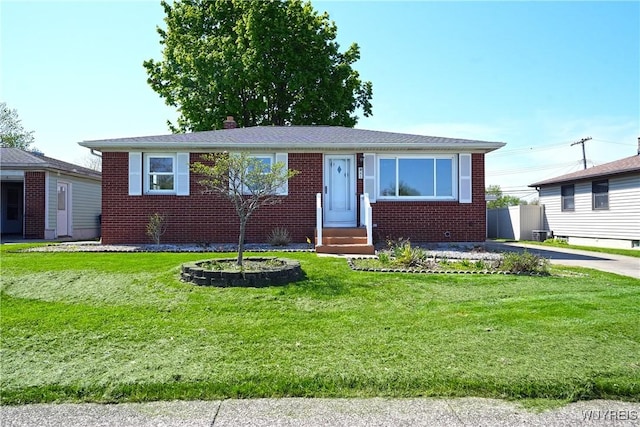 41 Della Dr, Lackawanna, NY 14218 - view of front of house with brick siding, entry steps, a front lawn, and a chimney