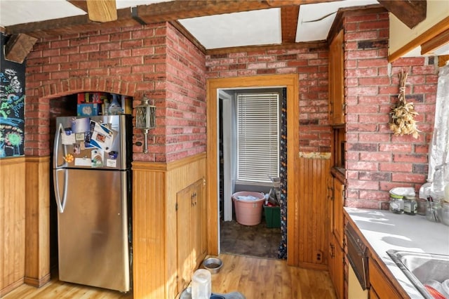 136 Summit St, Batavia-City, NY 14020 - kitchen with freestanding refrigerator, light wood-style floors, wainscoting, wooden walls, and dishwashing machine