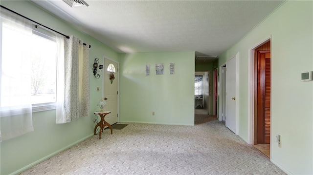 unfurnished room featuring carpet and baseboards