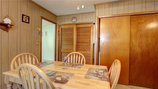 dining room featuring wooden walls