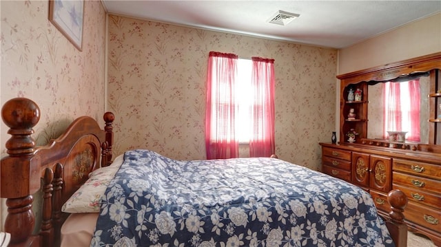 bedroom featuring wallpapered walls
