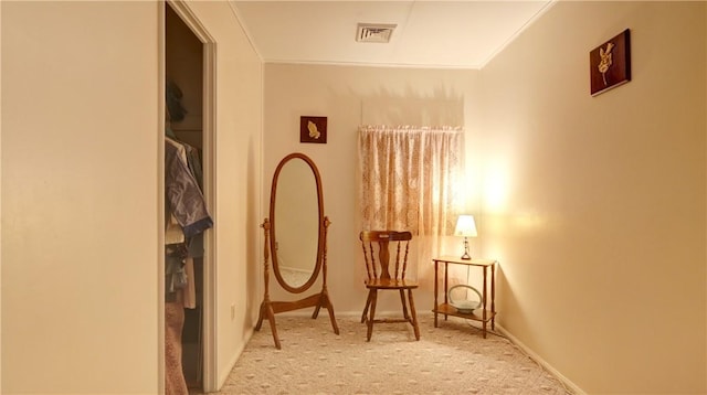 living area featuring crown molding, carpet floors, and baseboards