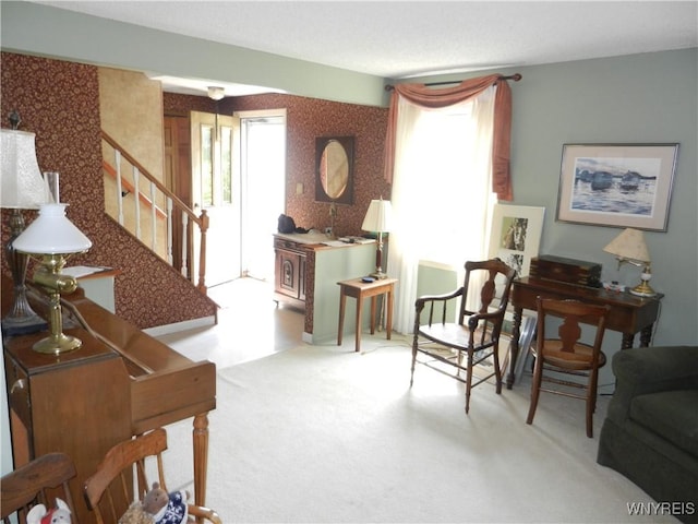 living area featuring stairs and carpet floors
