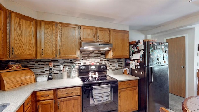 6 Club View Dr, Bath, NY 14810 - kitchen with black appliances, under cabinet range hood, backsplash, light countertops, and brown cabinetry